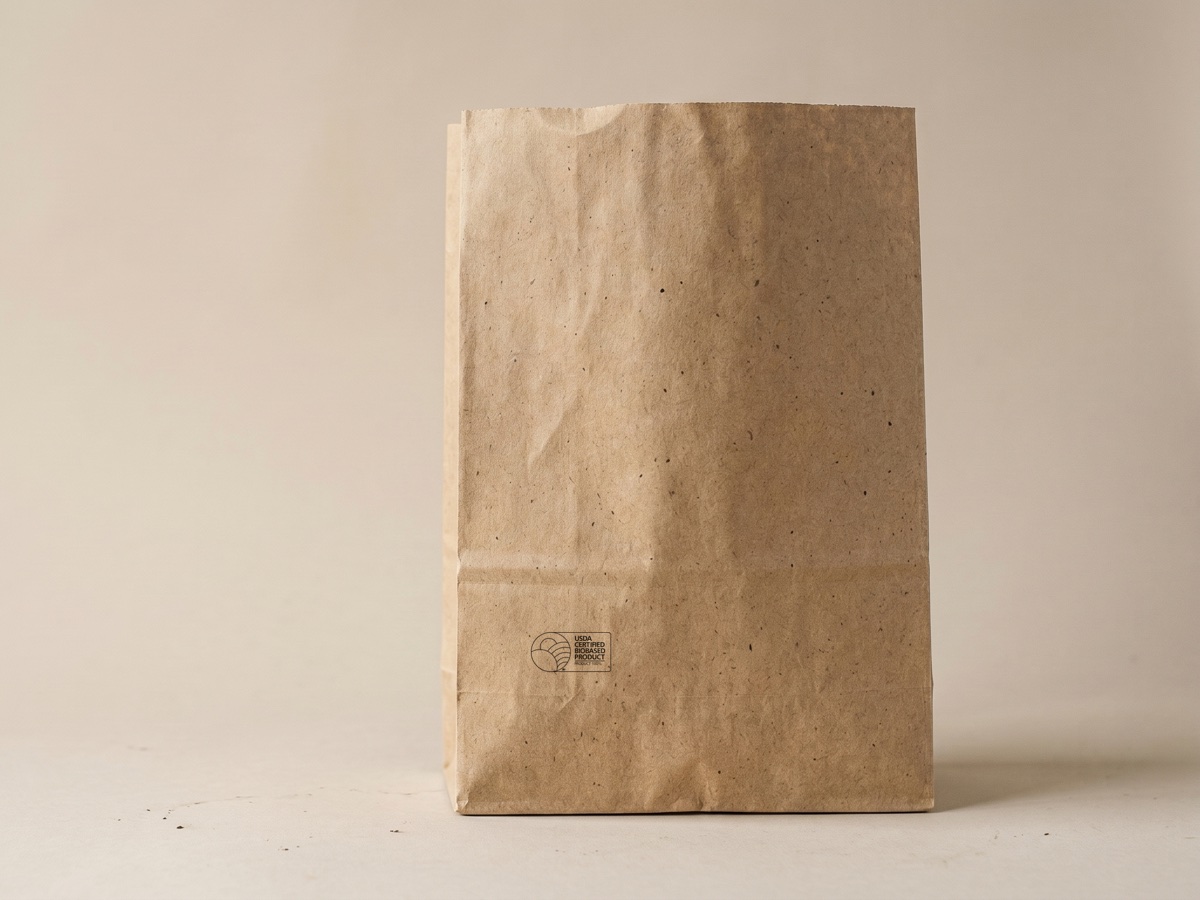 Single blank natural kraft hemp paper SOS grocery sack with no handles and a USDA Certified Biobased stamp in the bottom corner
